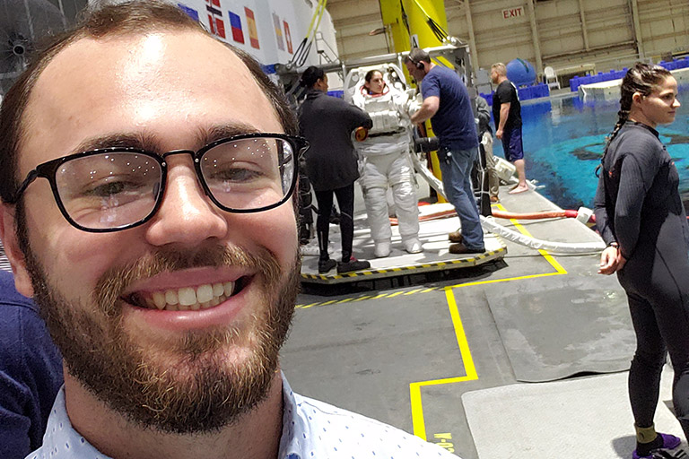 Miller McSwain takes a selfie in front of astronaut Jasmin Moghbeli.