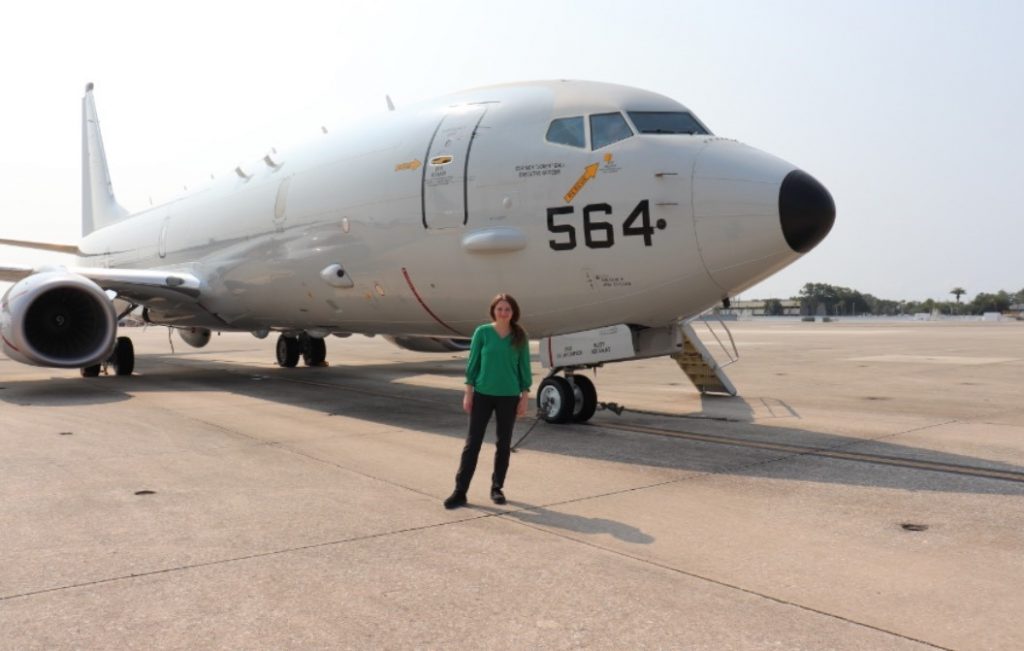 Amber Hiscock standing in front of an airplane
