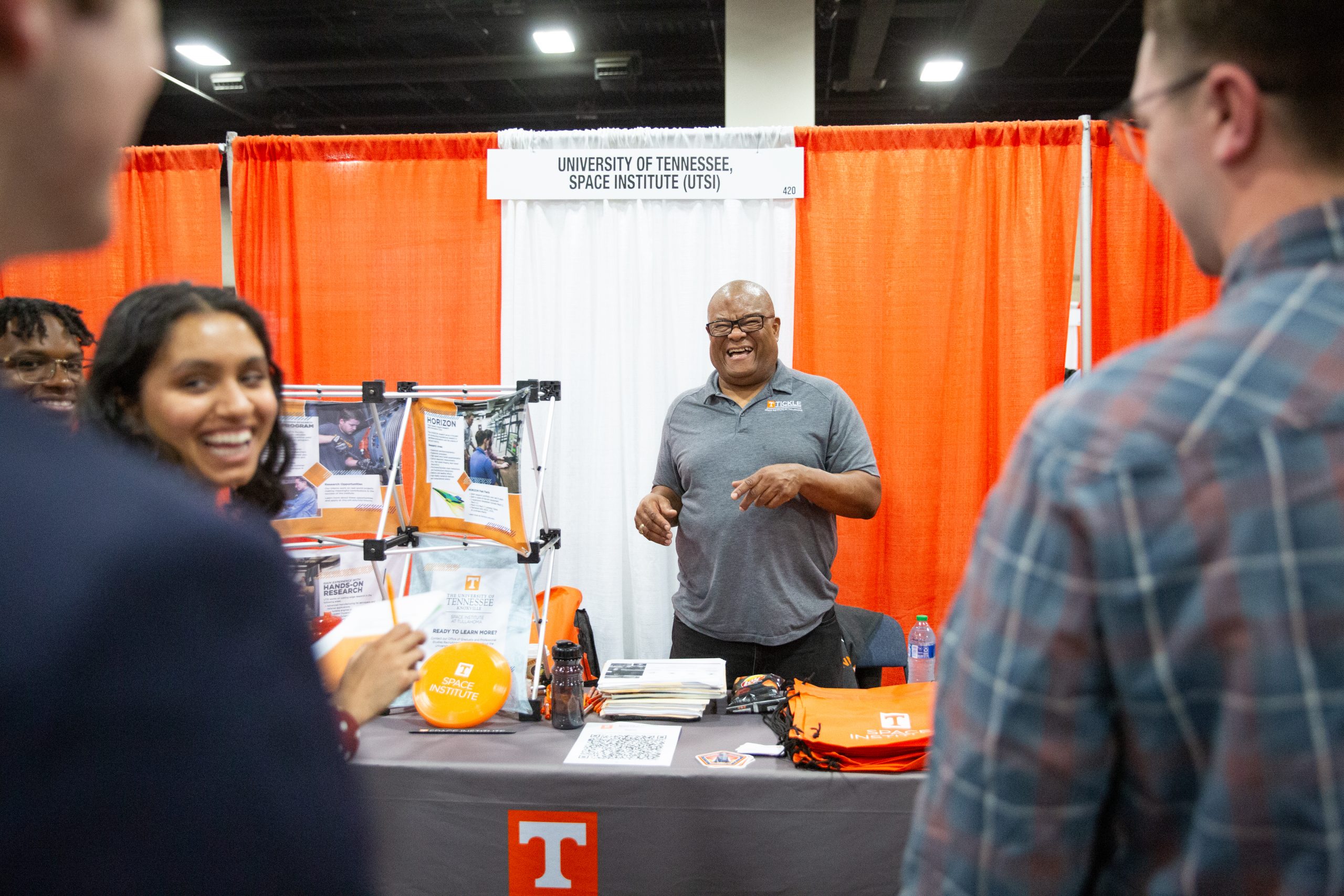 UTSI representative speaking with students at the spring 2024 engineering expo
