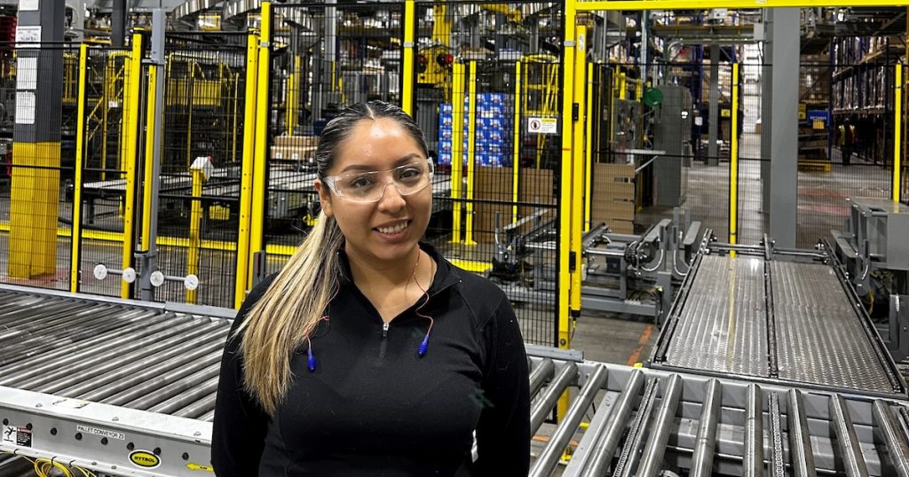 Valeria Huarote standing in the manufacturing plant of Keurig Dr. Pepper at their Knoxville location