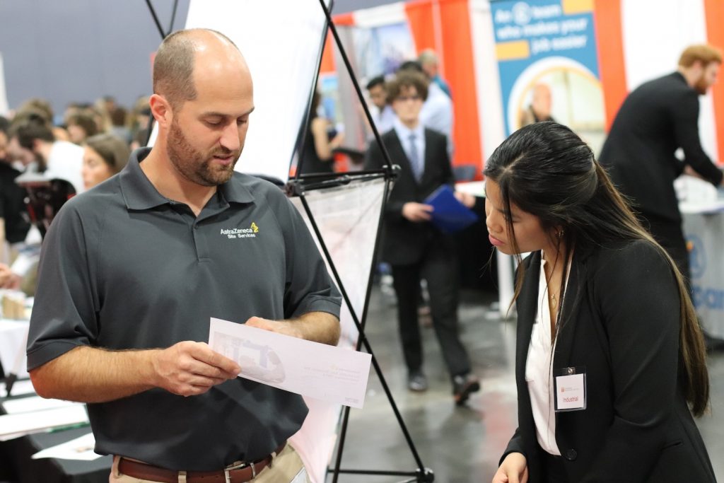 AstroZenica representative speaking with a female student