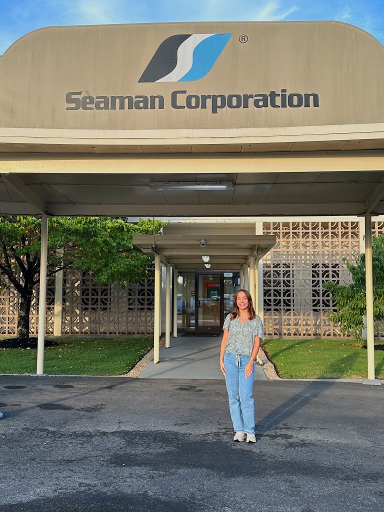 Emma Davis standing in front of the Seaman Corporation building