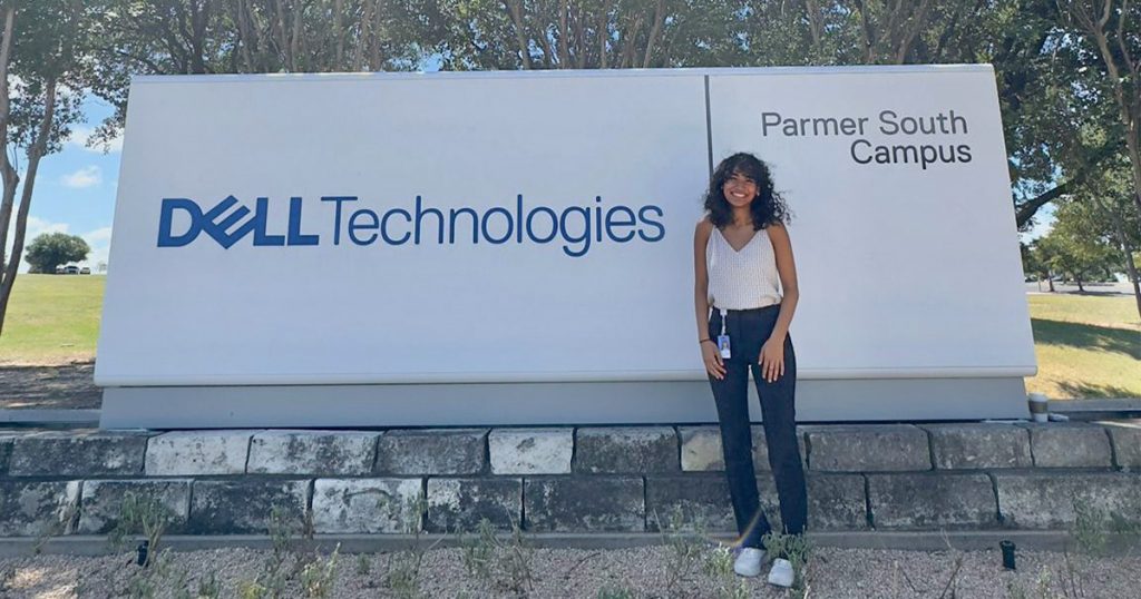 Isha Bhandari standing in front of the Dell Technologies sign in Austin, Texas