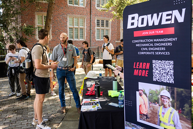 Bowen company representative speaking with engineering students at a cookout