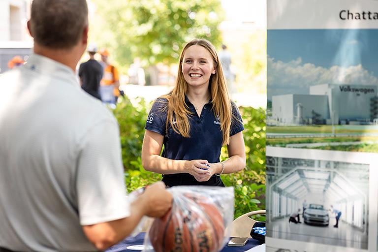 Female employer at Engineering Cookout speaking with a student