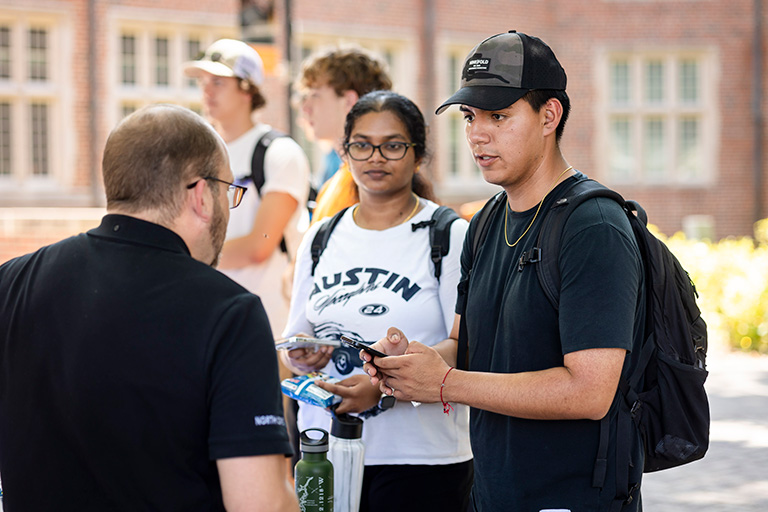 male and female student speaking with a company representative at the Engineering Cookout