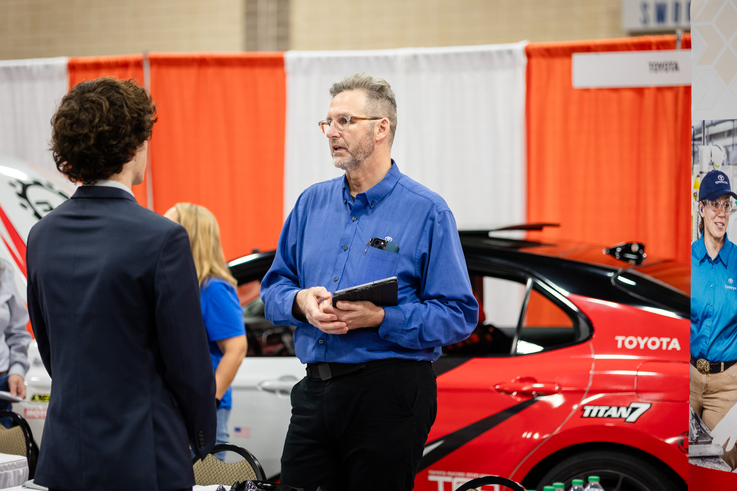 engineering student speaking with a Toyota representative at the Engineering Expo