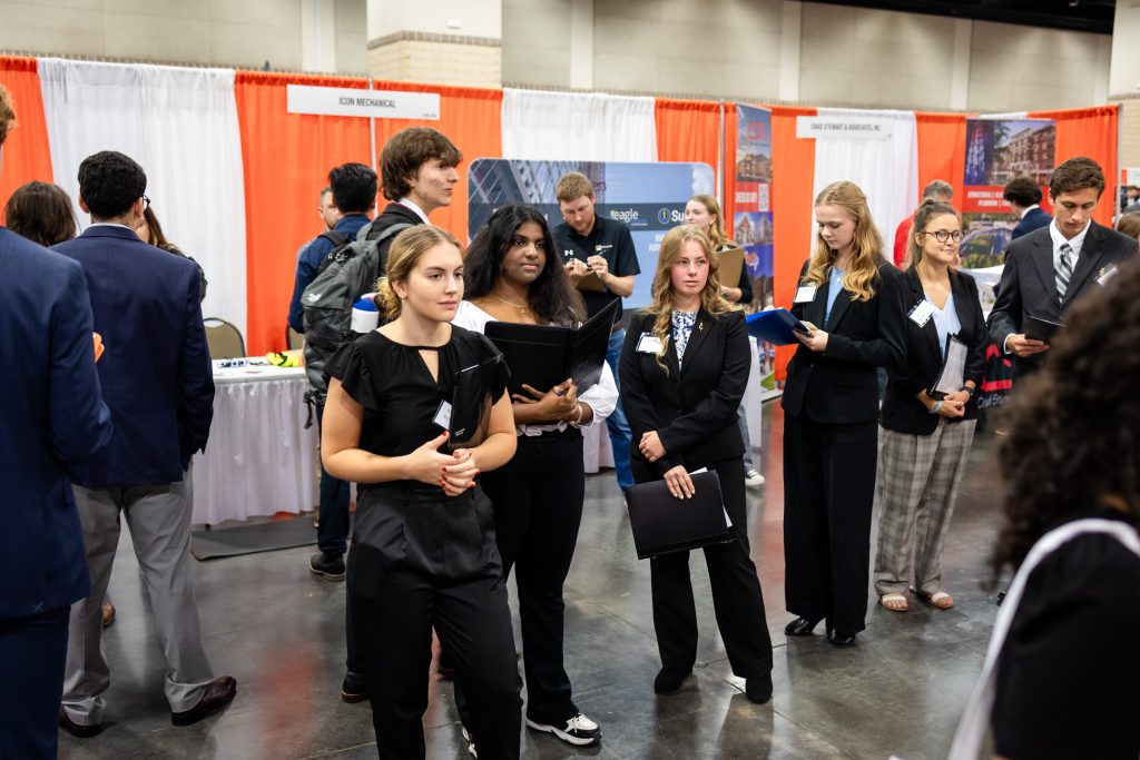 female students waiting in line to speak with an employer at the Engineering Expo