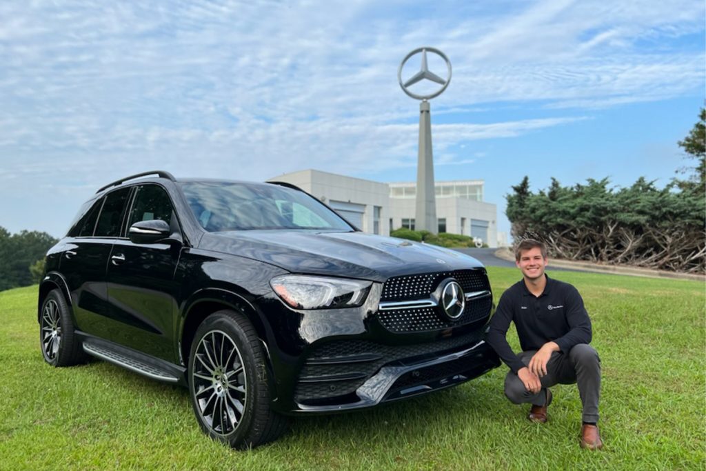 Blake Zegiestowsky with a black Mercedes