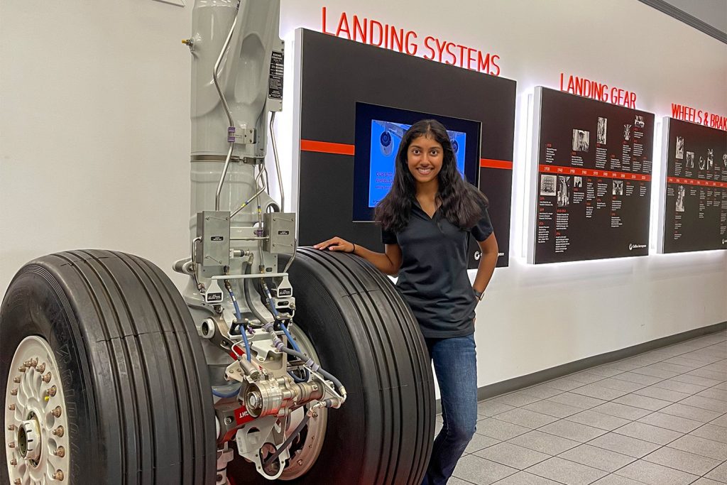 Kasthuri Pillapalayam standing next to airplane wheels