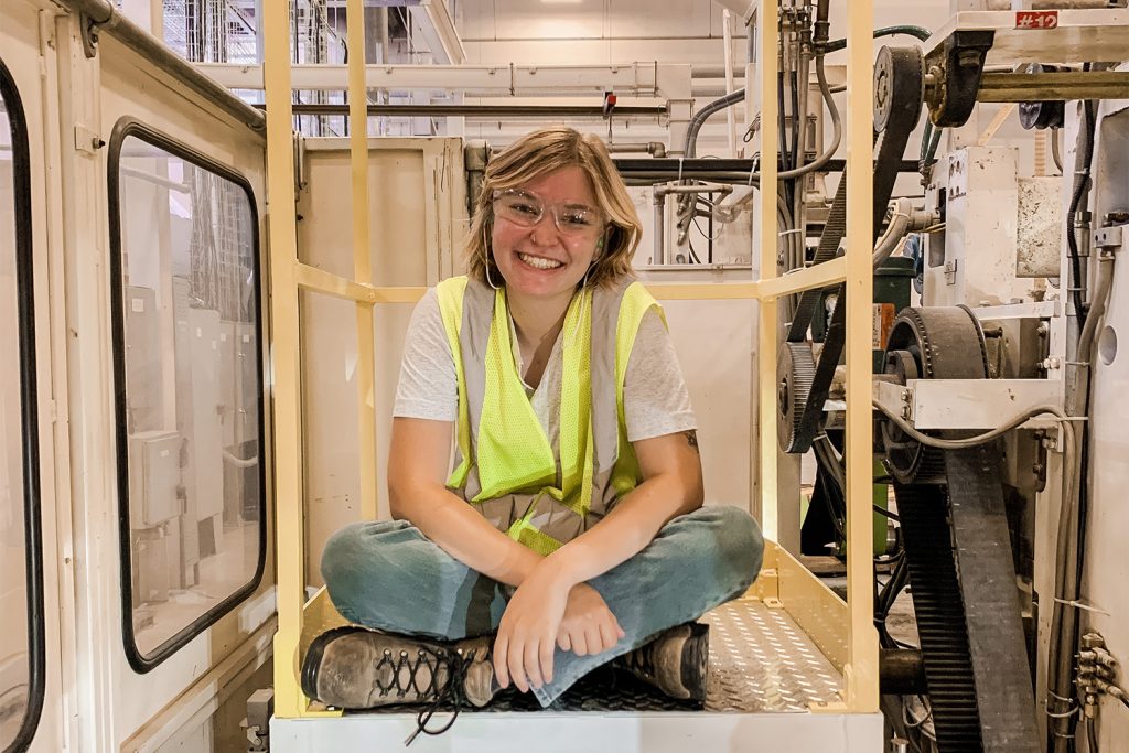 Addison Cable sitting on a machine in a factory