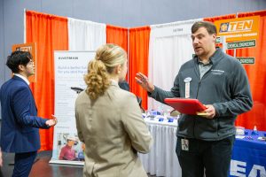 An Eastman representative talks to a student at the Engineering Expo