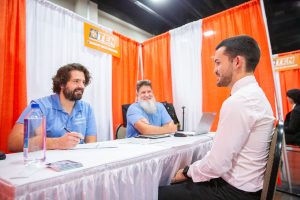 Two Greenheck Group representatives interviewing a student at the Engineering Expo